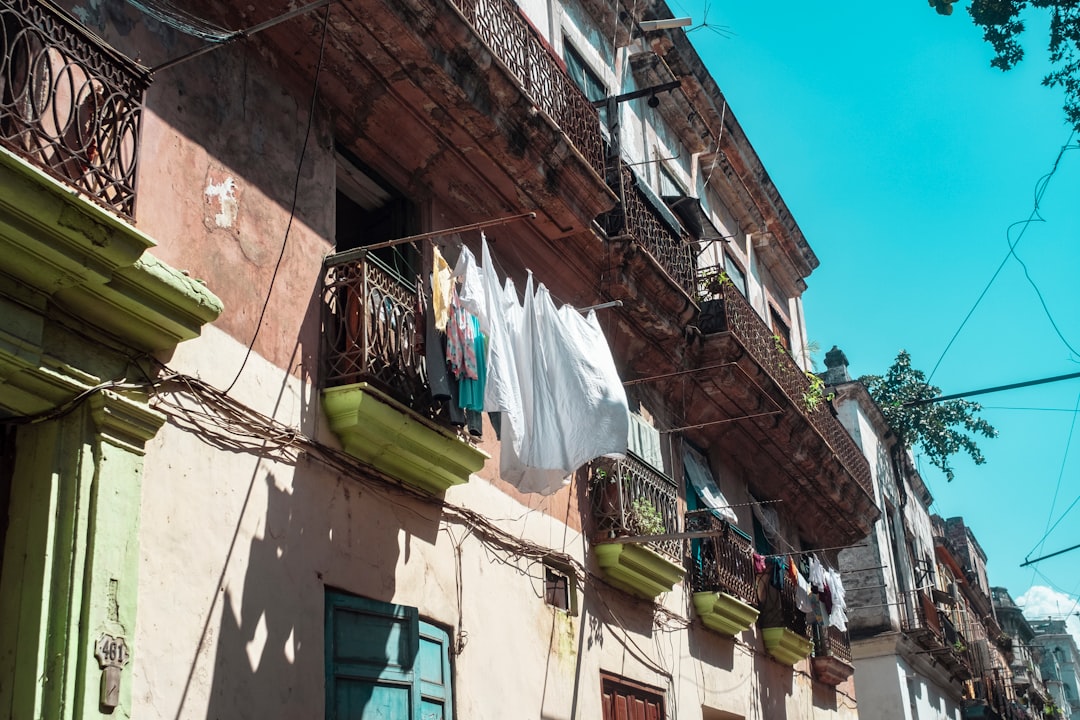 clothes hanged on wire near building during daytime