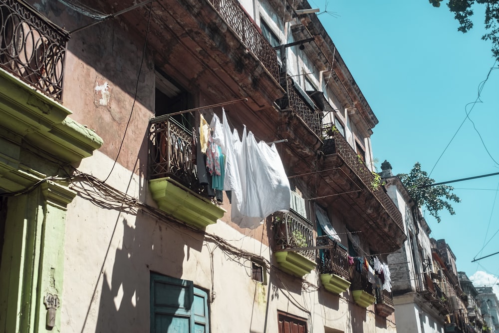 clothes hanged on wire near building during daytime