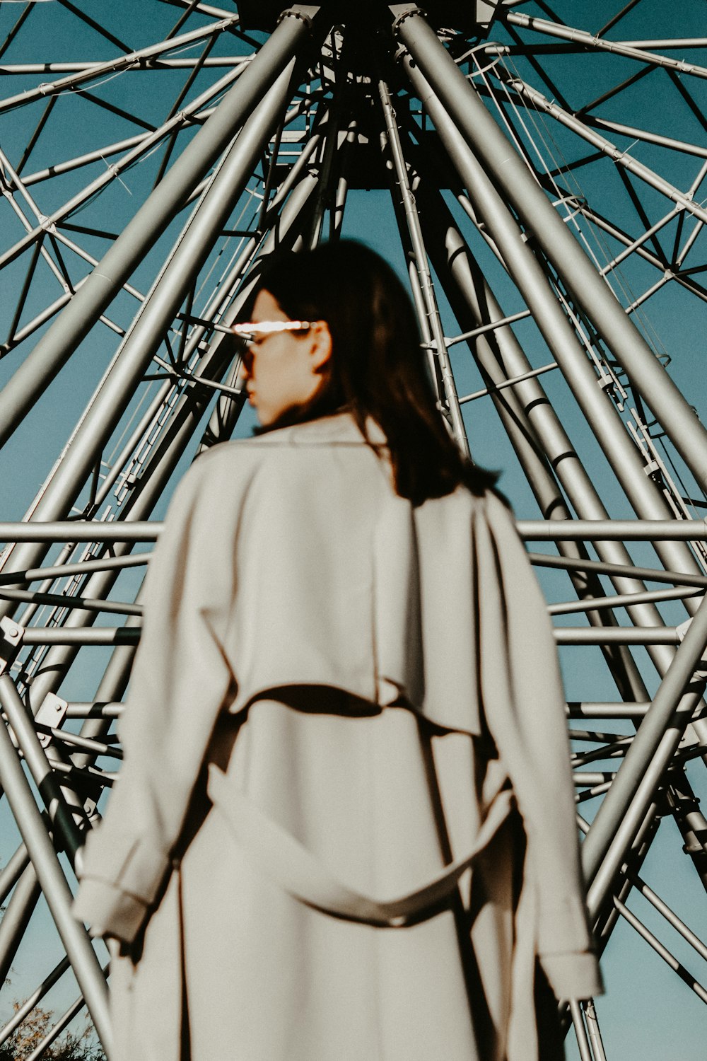 woman in white turtleneck sweater standing on blue metal ladder