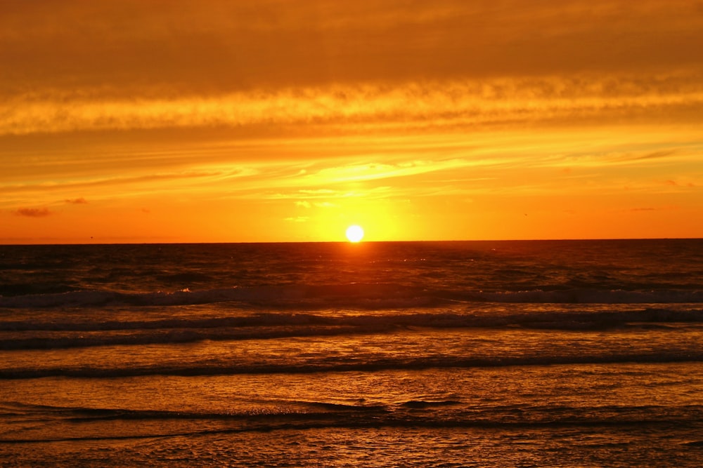 body of water during sunset