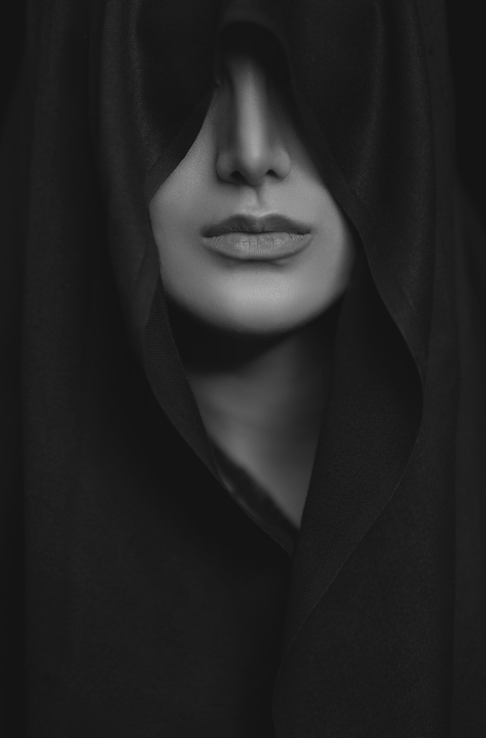 woman in black coat in grayscale photography