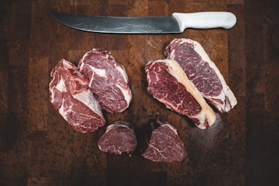 sliced meat beside silver knife meat google meet background