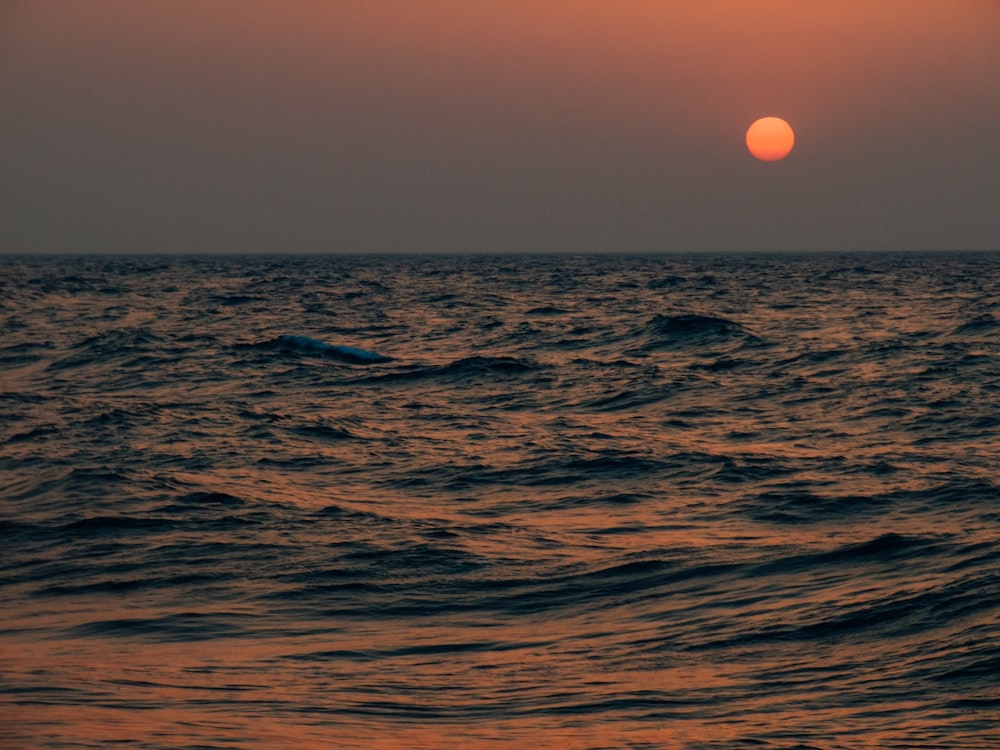 body of water during sunset