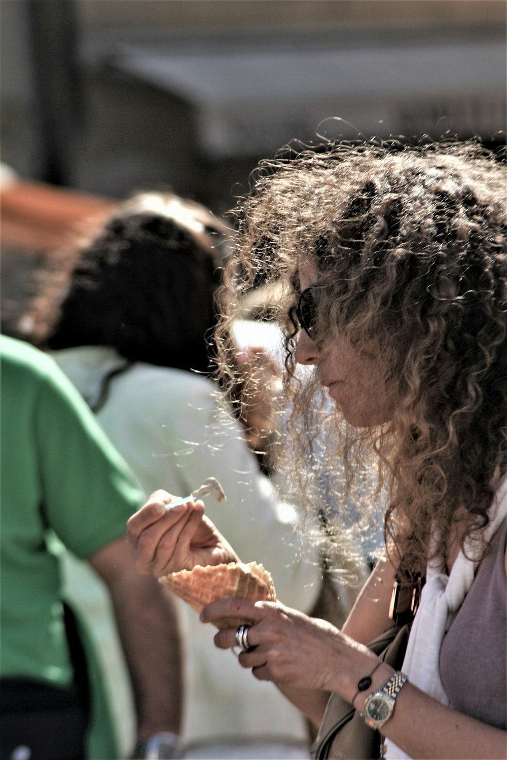 woman in white shirt holding brown bread