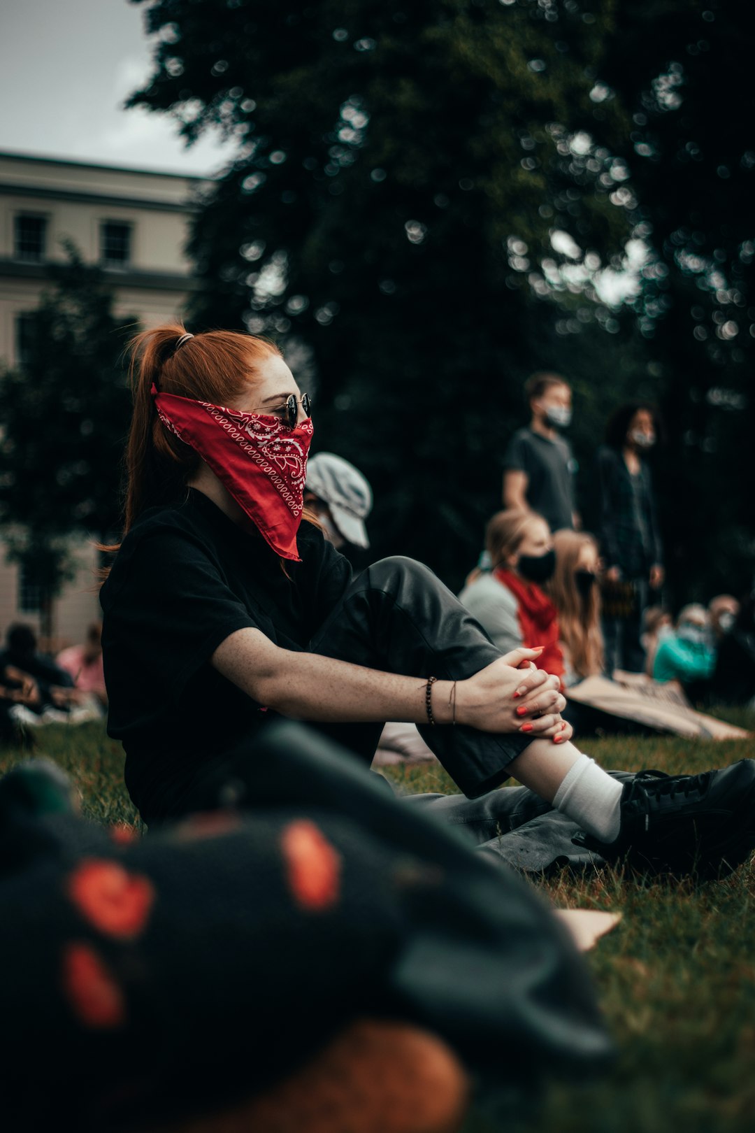 woman in black jacket wearing red and white mask