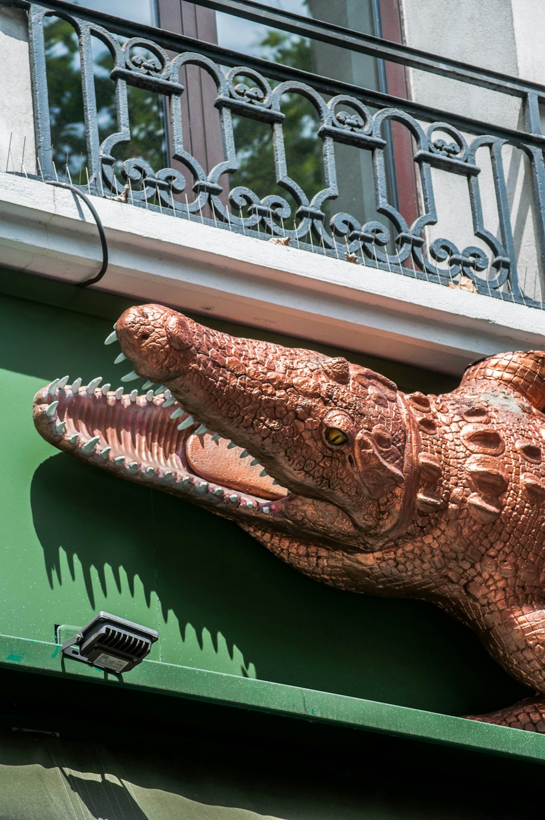 brown crocodile figurine on green textile