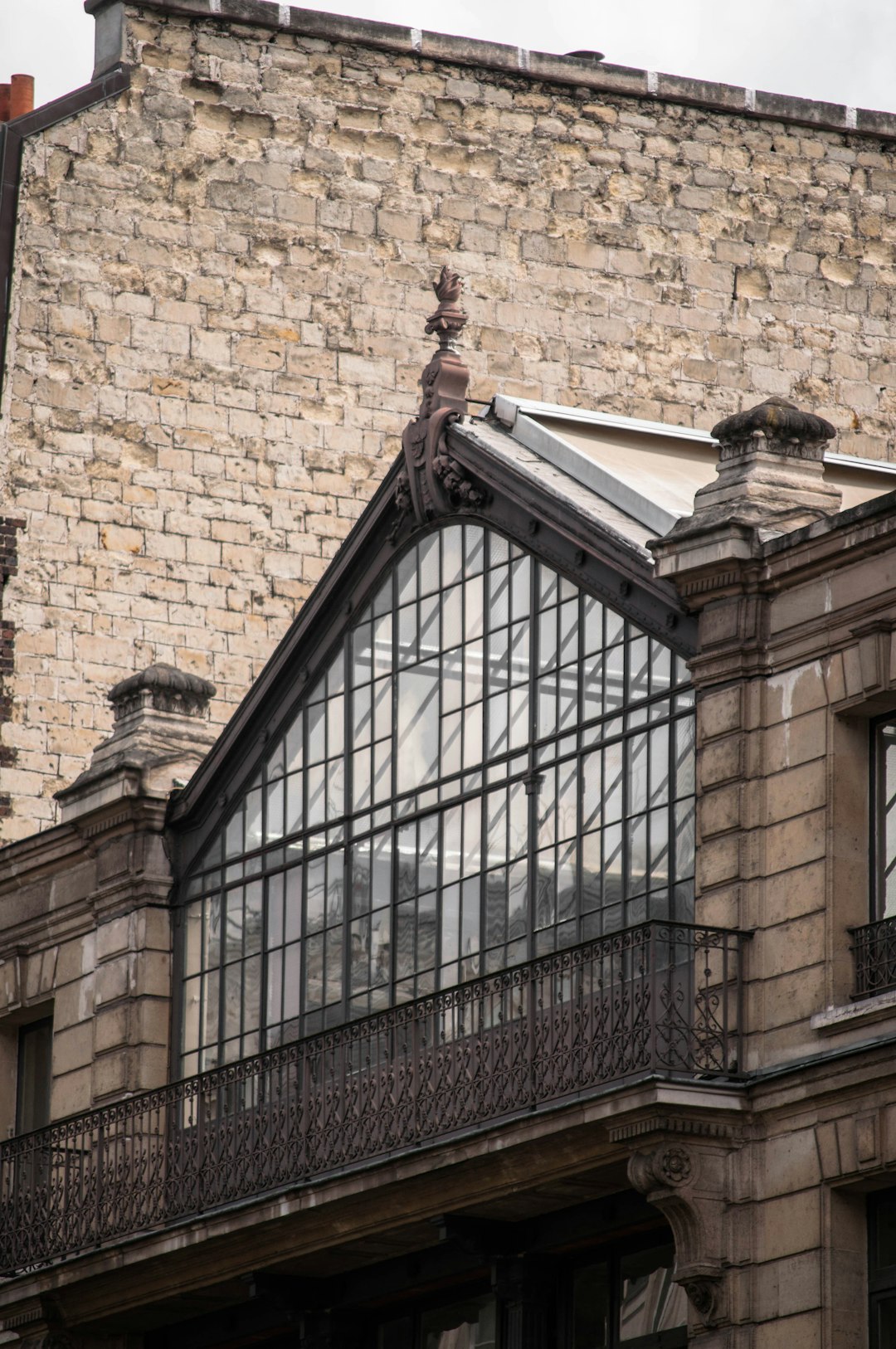 brown brick building with black metal window grill