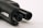 Close-up of the barrel and part of a firearm, focusing on the metal components and details. The surface texture and dark coloration dominate the image.