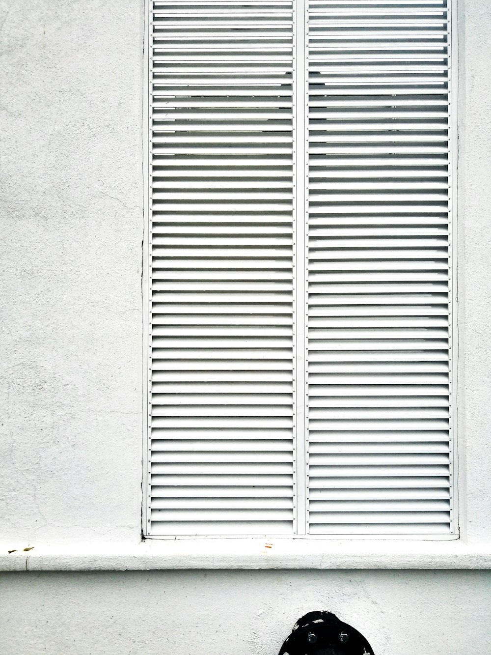 white wooden window frame on gray concrete wall