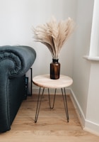 A stylish wooden table with metal legs in a cozy living room.