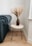A beautifully crafted wooden table with industrial-style metal legs in a cozy living room.