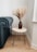 A beautifully crafted wooden table with industrial-style metal legs in a cozy living room.