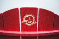 Close-up of Verdevita's Adirondack chair with natural wood grain and a sunset in the background.