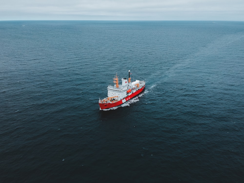 red and white ship on sea during daytime