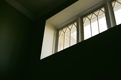 A variety of window styles displayed in a showroom setting with natural daylight.