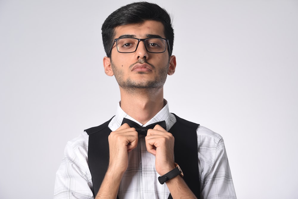 man in black and white dress shirt wearing black framed eyeglasses