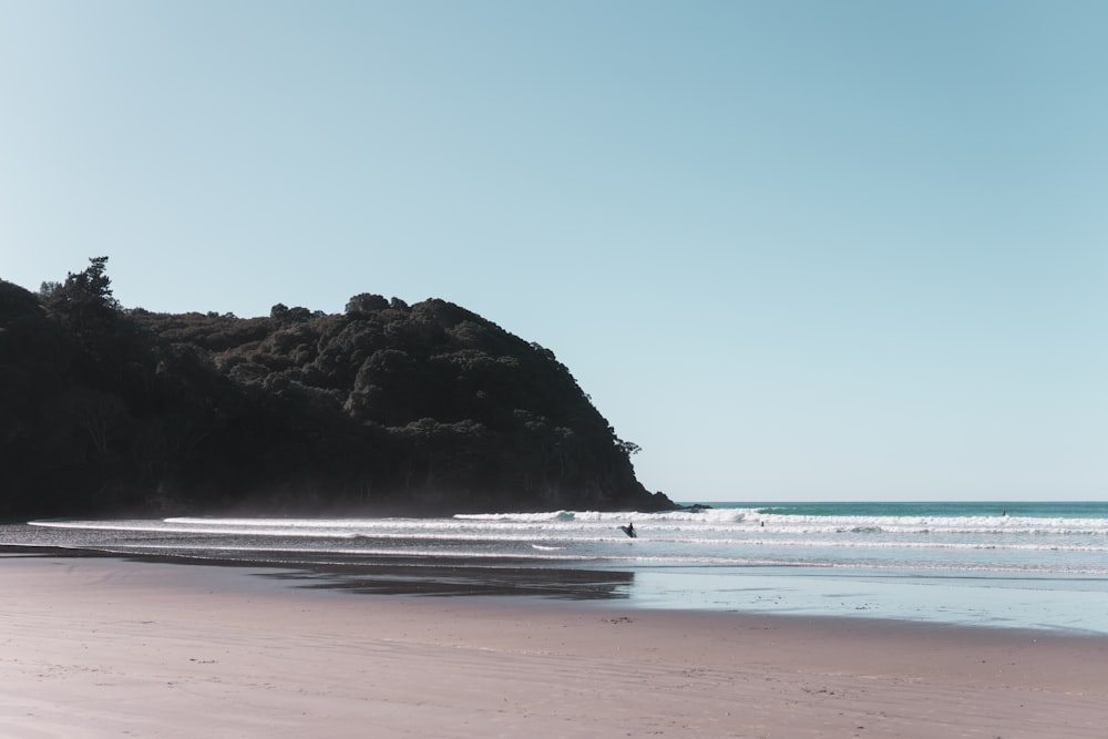 brown rock formation on sea shore during daytime