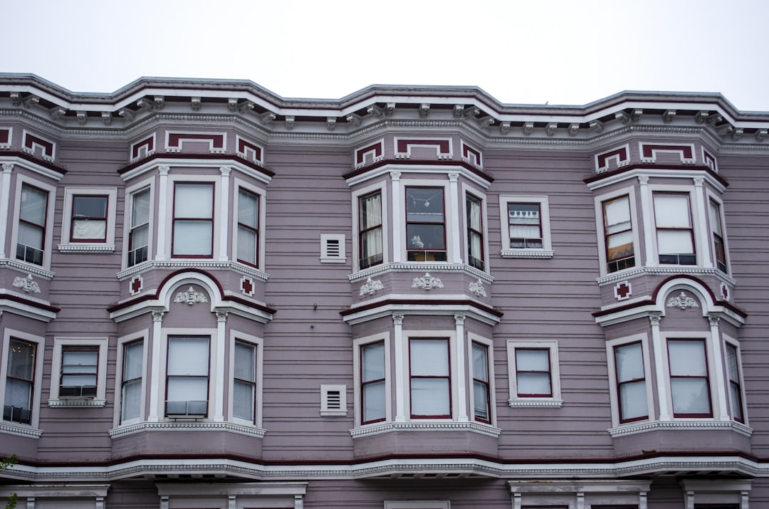 red and white concrete building, Pink Victorian townhouses