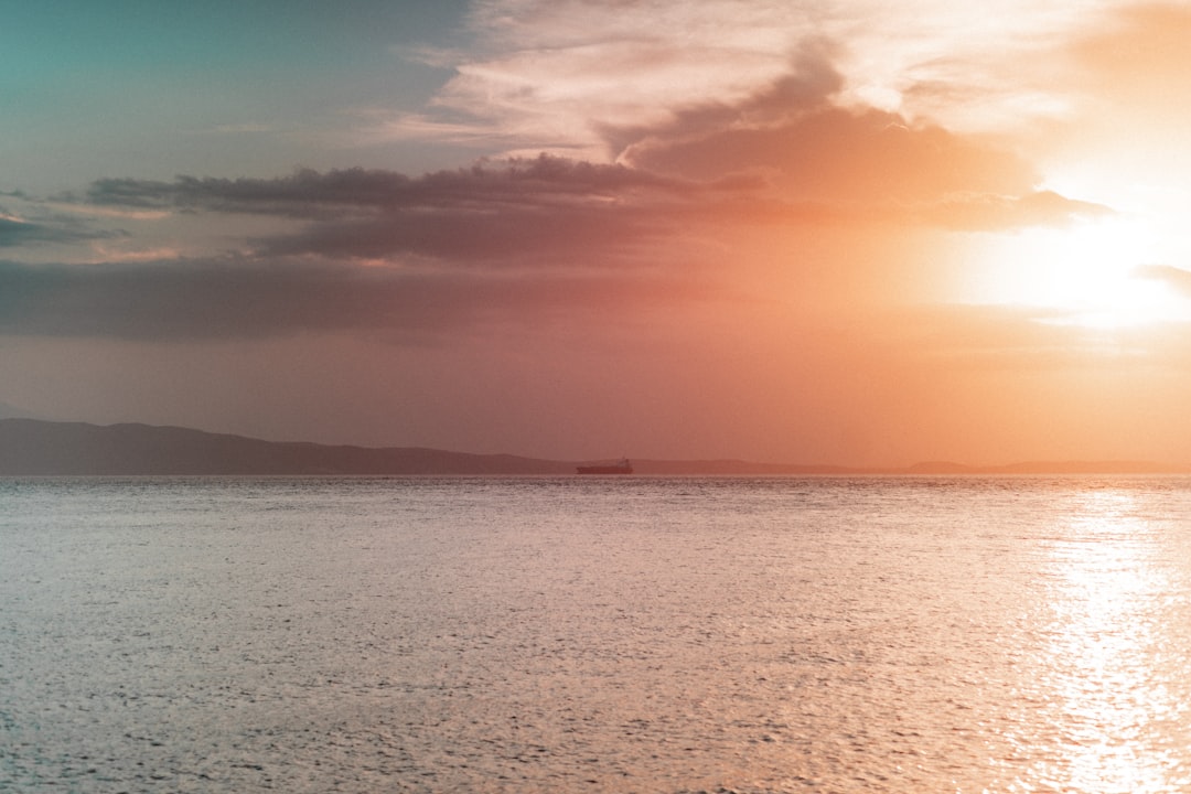 body of water under cloudy sky during daytime