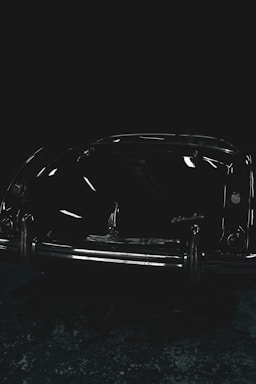 A vintage Cadillac CTS Coupe sitting in a well-equipped garage, spotlighting the passion behind technical mastery.