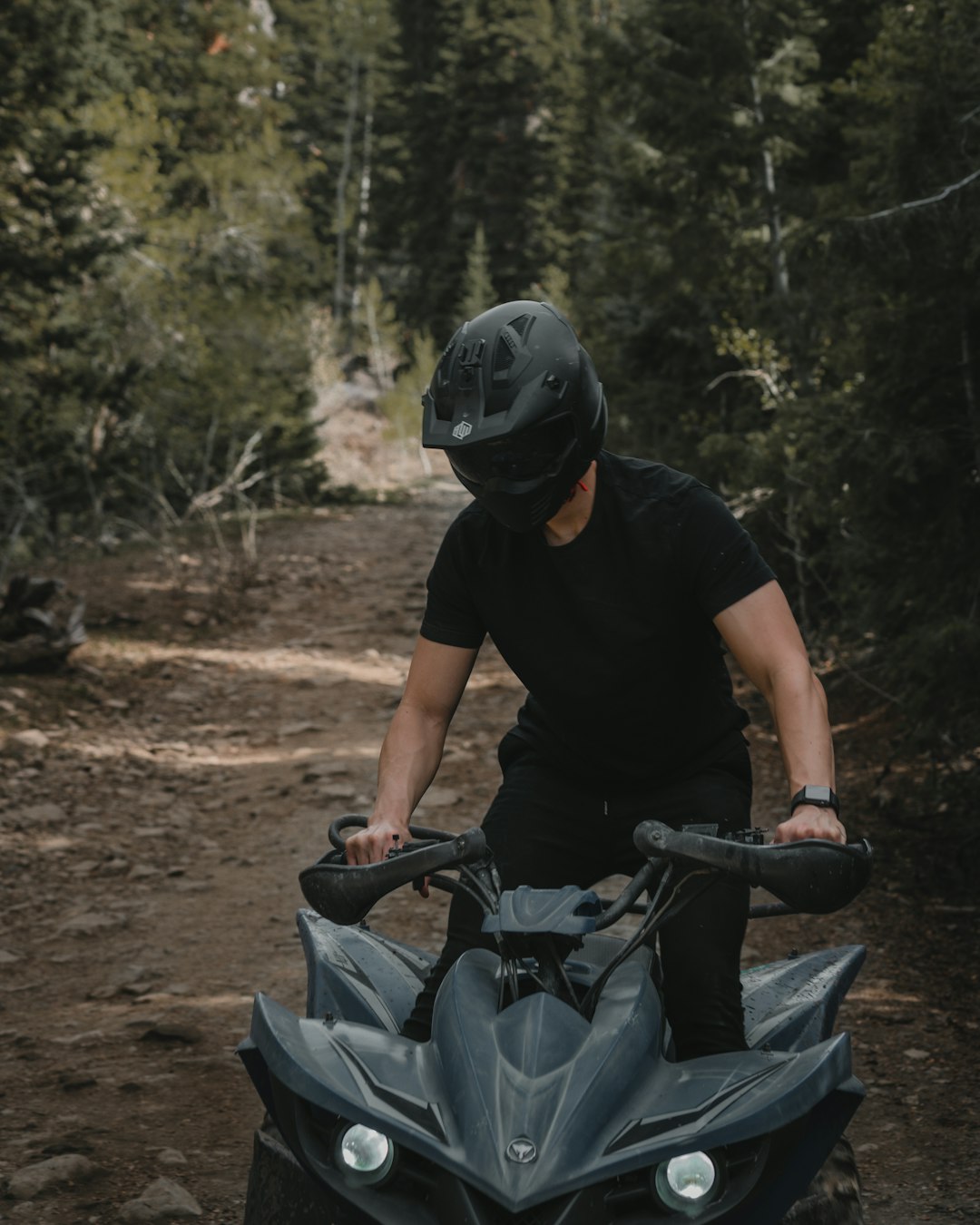 man in black t-shirt riding on bicycle during daytime