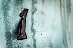 black metal tool on white concrete wall