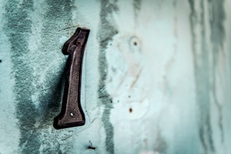 black metal tool on white concrete wall