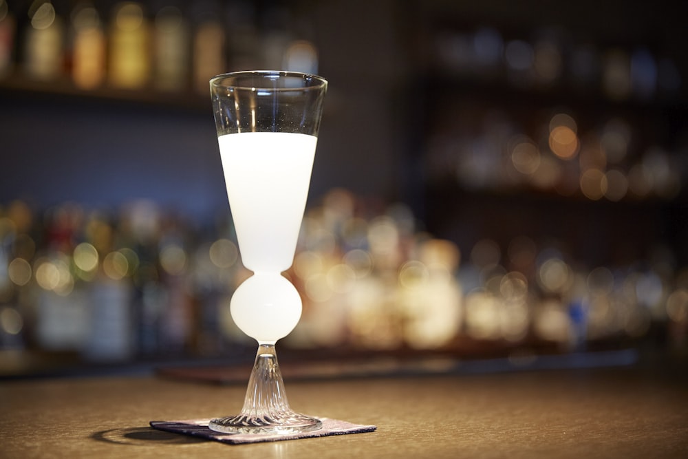 white wine glass on brown wooden table