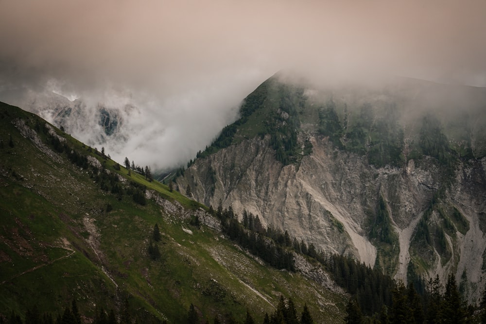 green and gray mountain under white clouds