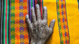 Close-up of colorful Mexican rebozo fabric used in a gentle massage.