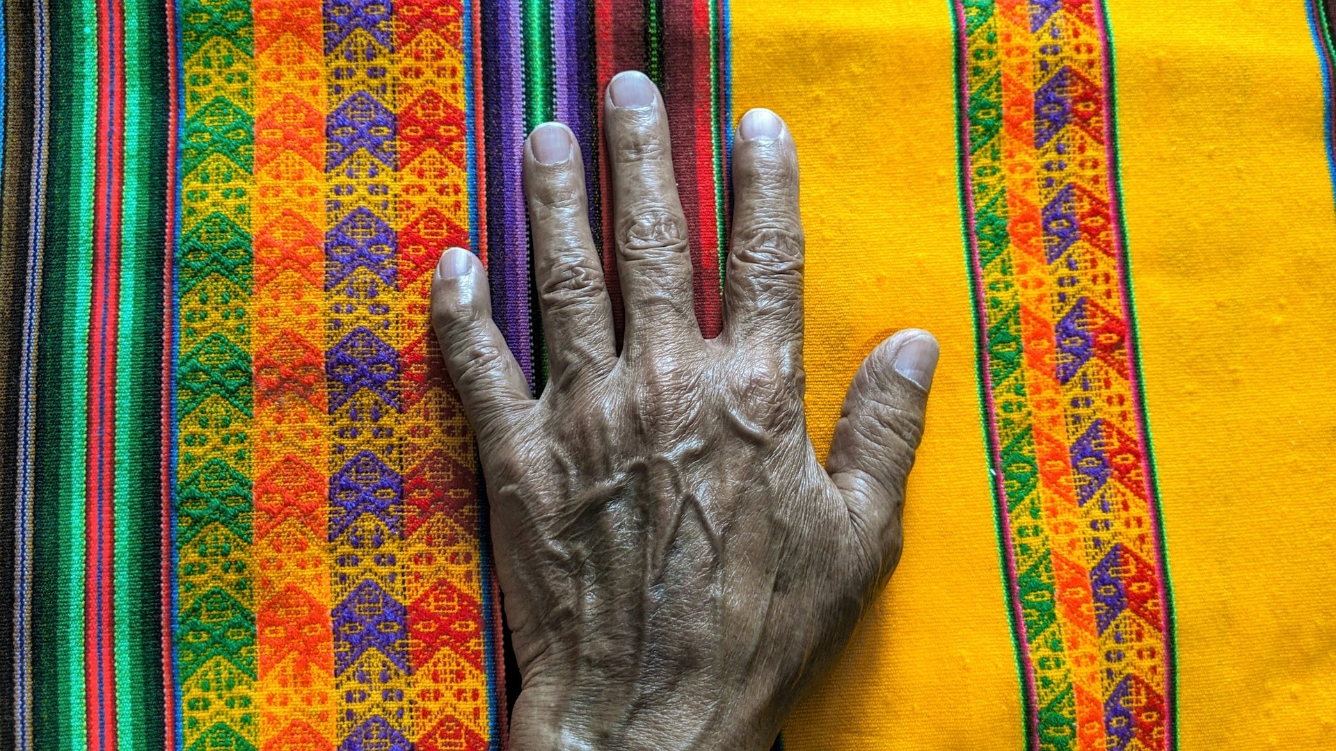 woman wearing yellow long-sleeved dress under white clouds and blue sky during daytime