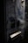 A close-up view of a worn, vintage vending machine with partial text reading 'einzigartig' on its surface. Smoking wisps trail across the machine, adding a mysterious and somewhat eerie effect. The machine appears old and slightly rusted, with dark blue and metallic tones.