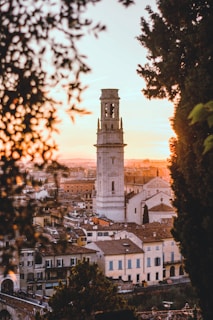 The bell tower of a parish church glowing warmly at sunset.