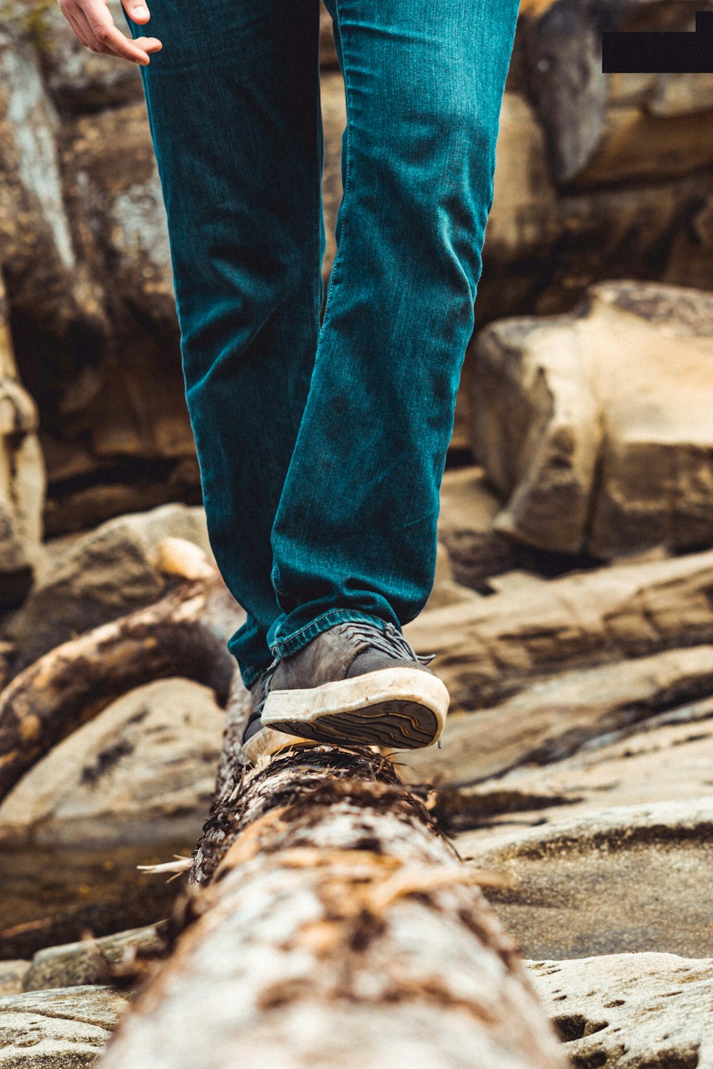 person in blue denim jeans and brown hiking shoes