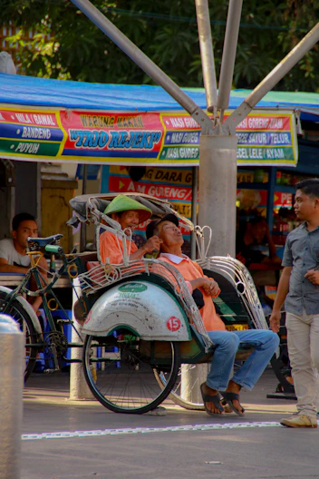 people riding on white and red motorcycle during daytime