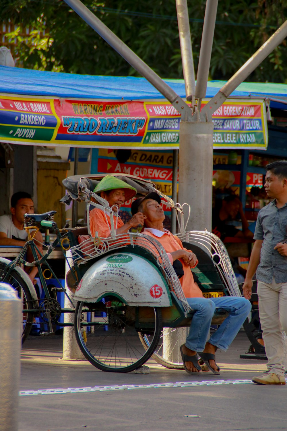 people riding on white and red motorcycle during daytime