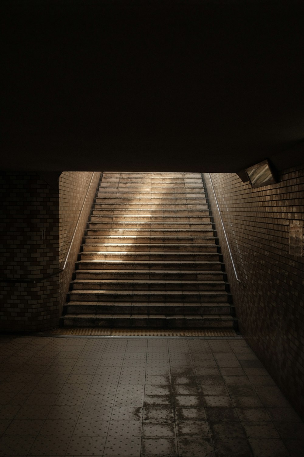 brown brick wall with black metal railings