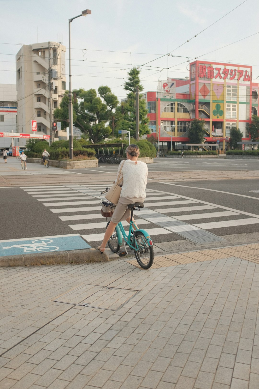 man in white long sleeve shirt riding blue bicycle on pedestrian lane during daytime