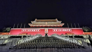 Evening exterior view of the illuminated Canton Fair complex with visitors arriving
