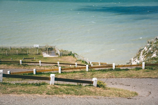white wooden fence near body of water during daytime in Baie de Somme France
