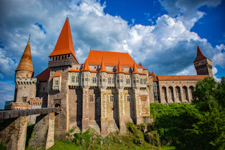 A sprawling medieval castle under construction with players collaborating.