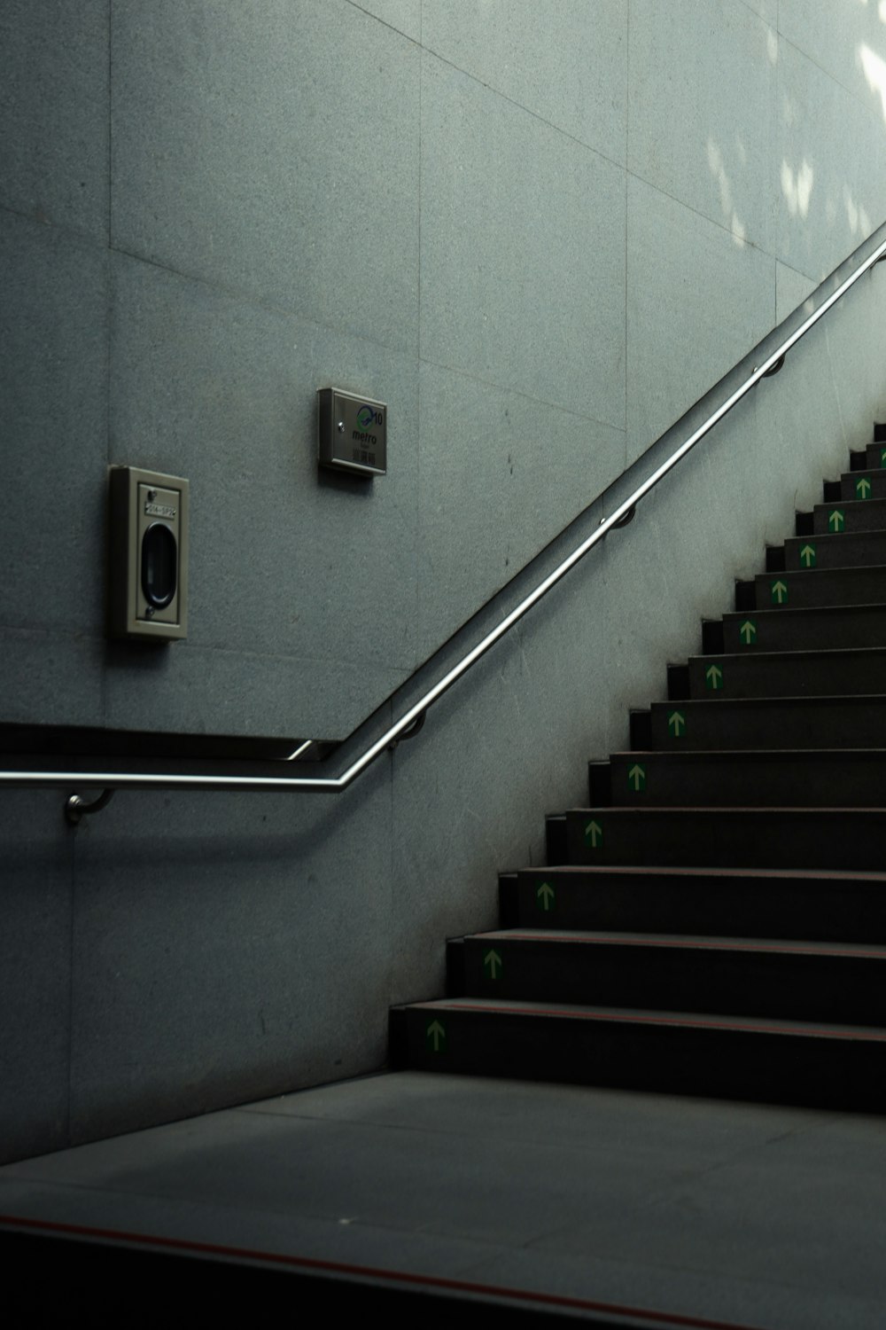 green and white staircase with stainless steel railings