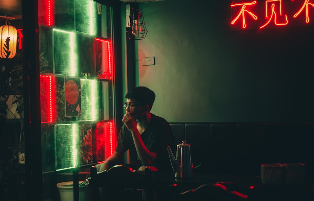 man in black shirt sitting on chair