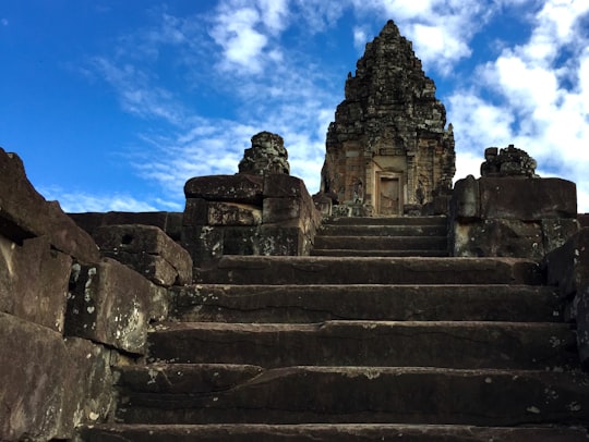 gray concrete stairs under blue sky during daytime in Bakong Cambodia
