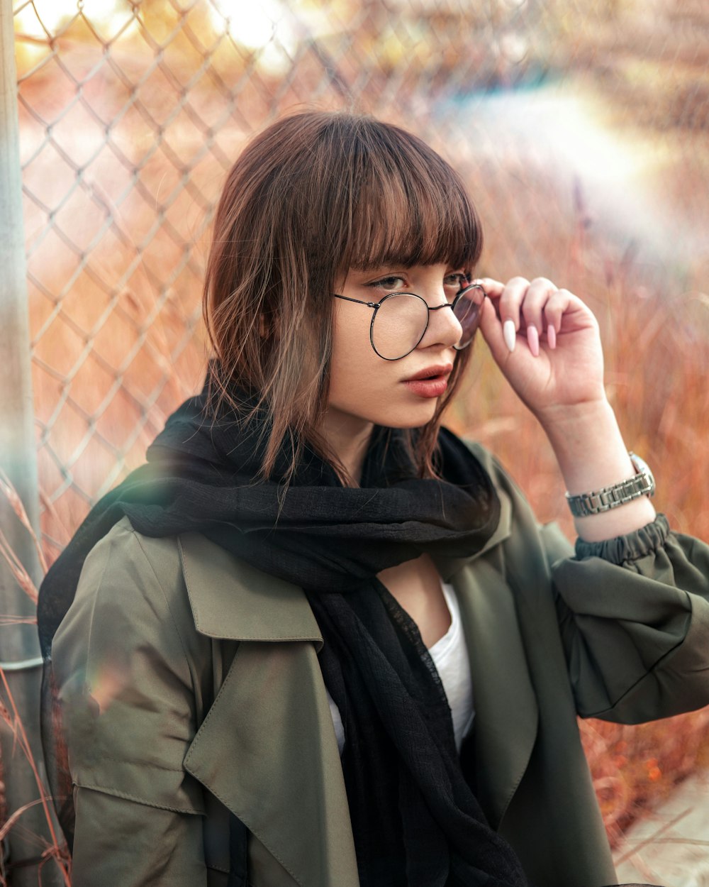 woman in black framed eyeglasses and gray coat