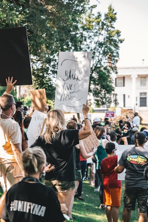 A group of diverse activists holding signs during a peaceful social justice rally.