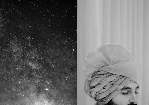 A serene portrait of Astrologer Pradeep against a backdrop of subtle celestial constellations in deep navy and muted gold.