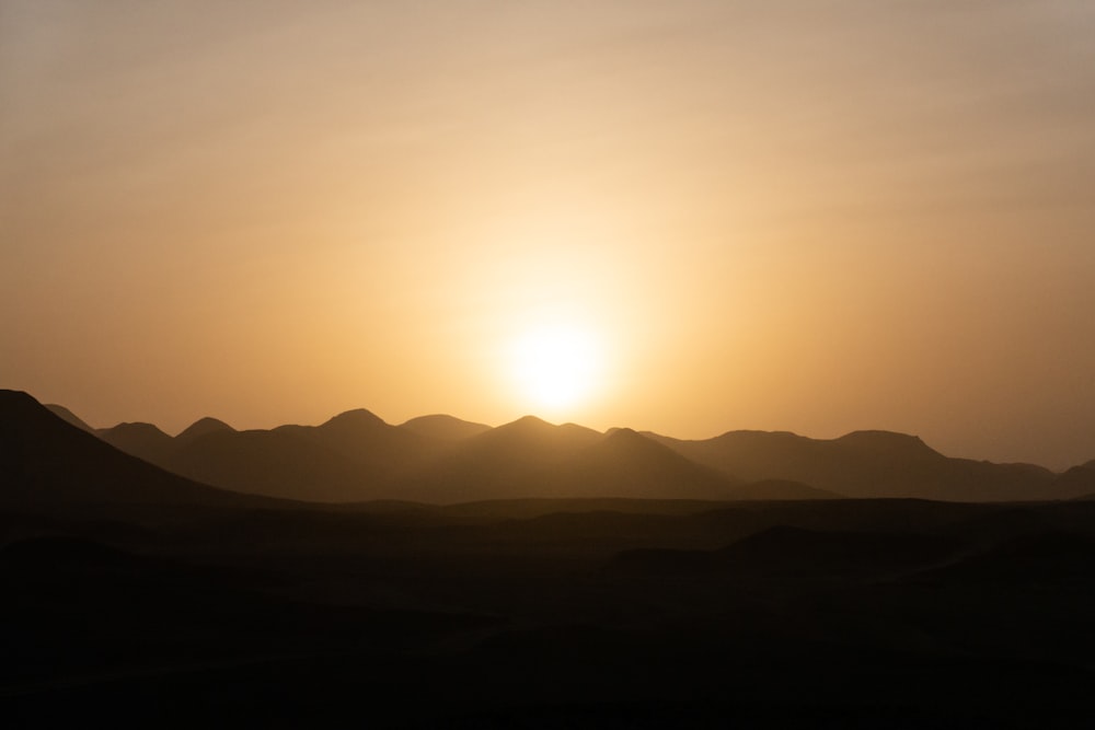 silhouette of mountains during sunset