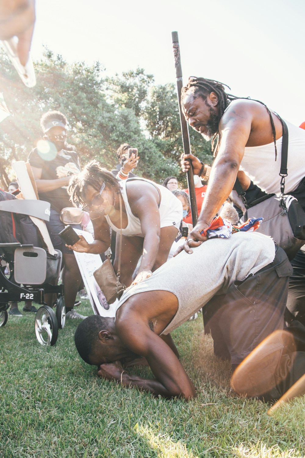 man in black tank top sitting on black camping chair