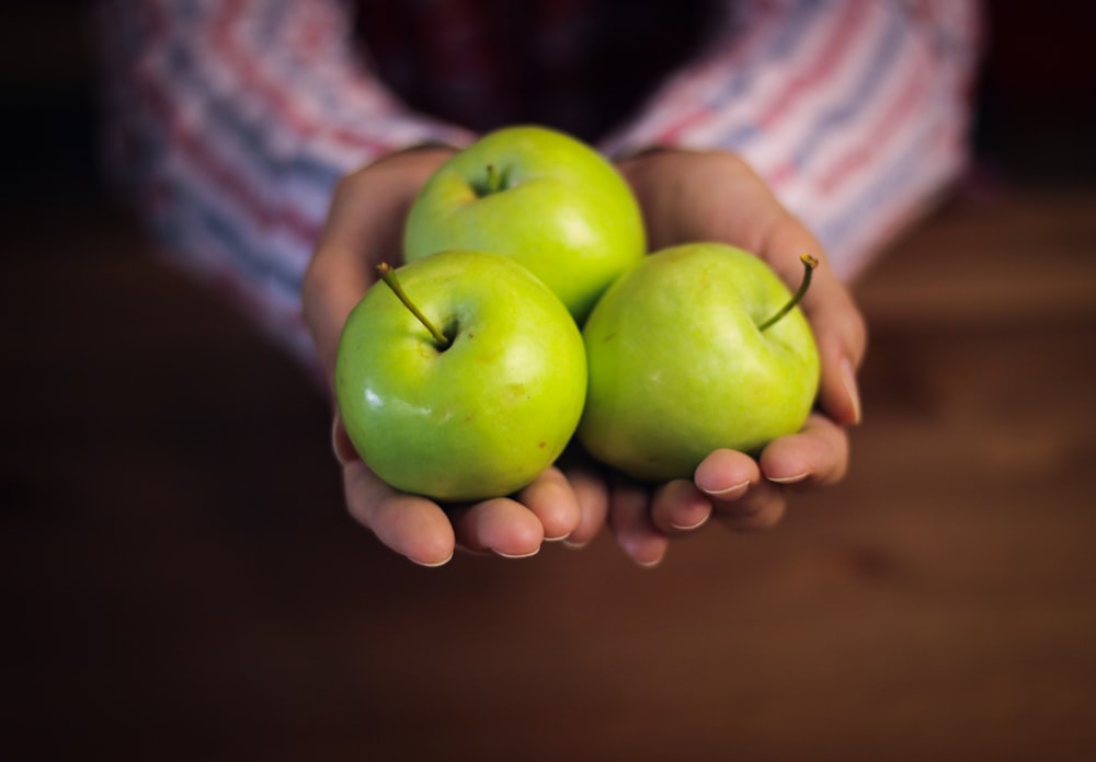 green apples on brown wooden table